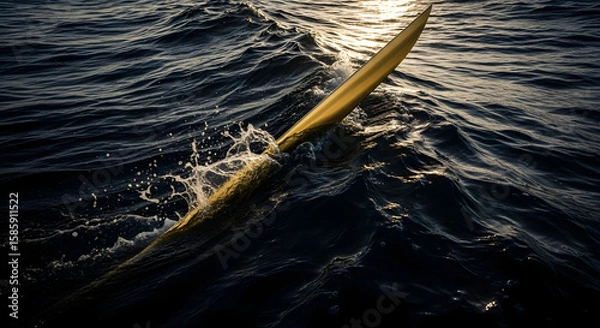 Fototapeta A blue boat sails across the shimmering surface of the ocean, its wake a white foam on the summer waves, inviting travel and sport in nature's embrace
