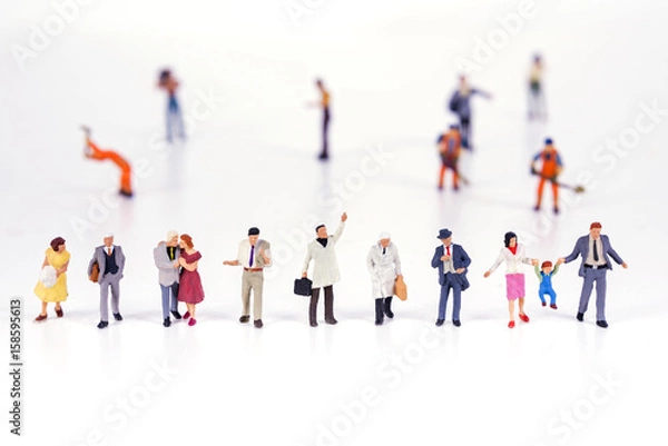 Fototapeta Line of diverse tiny miniature model people