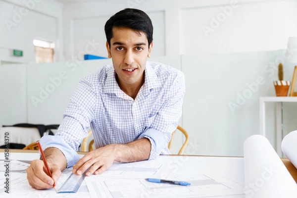 Fototapeta Young man architect in office