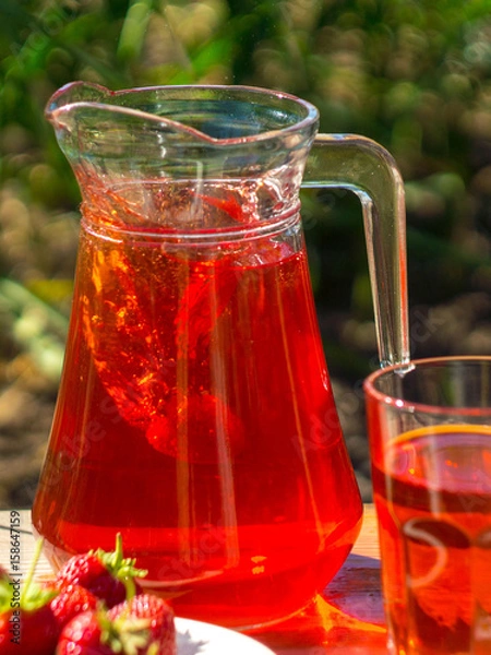 Fototapeta glass with strawberry juice and berries isolated on blur background