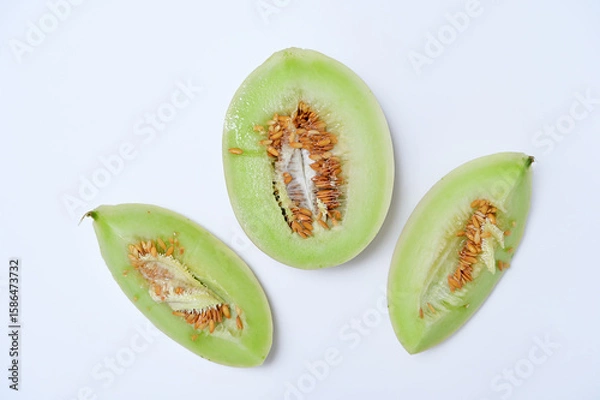 Fototapeta three pieces of melon on a white background flat lay