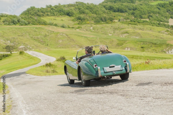 Fototapeta Two friends with a vintage car