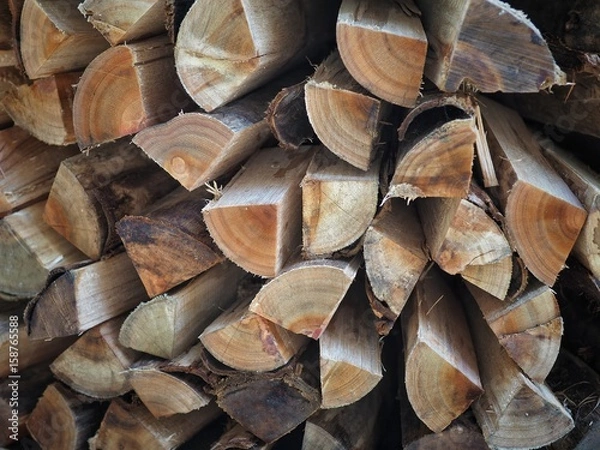Fototapeta Stack of chopped firewood logs background.
