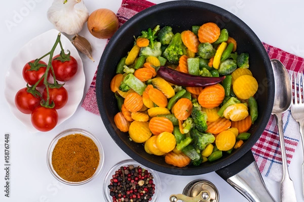 Obraz Frozen vegetables in frying pan for frying