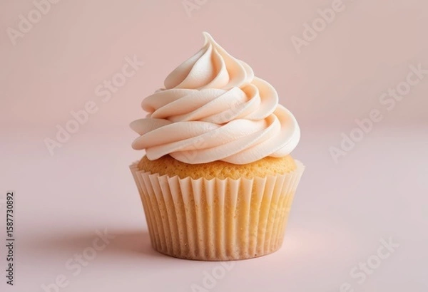 Fototapeta Vanilla Cupcake with Swirled Frosting on Soft Pink Background,  Vanilla cupcake with frosting