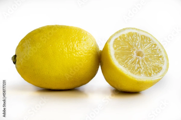 Fototapeta Some yellow, ripe and fresh lemons are on a white background