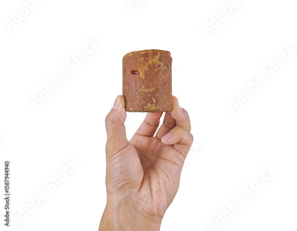 Fototapeta Palm sugar held by hand, representing organic sweetener from coconut or sugar palm tree