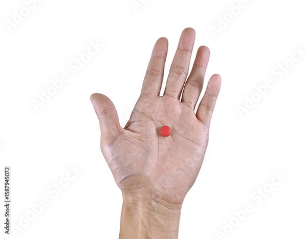 Fototapeta Conceptual image of blood health and supplementation, showing hand gripping a pack of hematinic tablets.