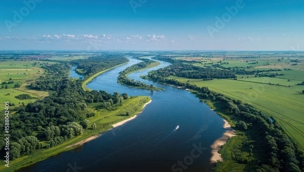 Obraz Serpentine river winds through verdant fields