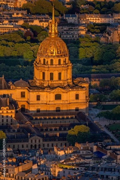 Fototapeta Close-up aerial view of the Golden Dome of the Invalides Palace beautifully illuminated during the golden hour at sunset in Paris.