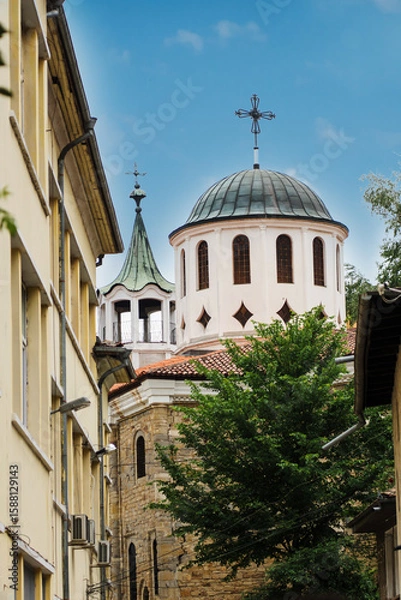Obraz View of the Church of Saints Constantine and Helena from a narrow street in the medieval town of Veliko Tarnovo in Bulgaria. The concept of tourism and travel