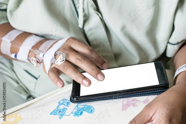 Obraz asia woman in hospital room on bed sick and injured is using mobile phone. blank display for graphic designer