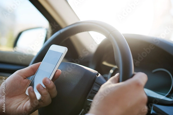 Obraz Man texting message in a car