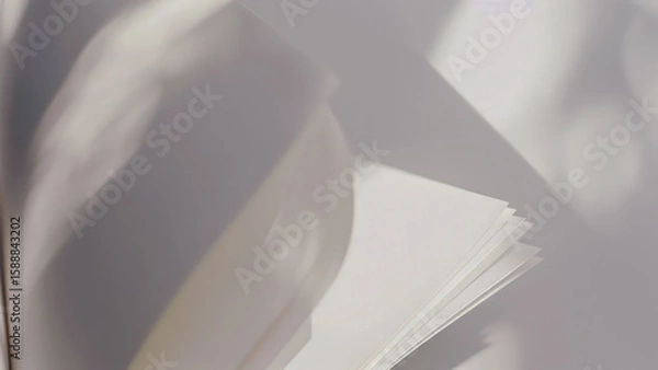 Fototapeta Abstract close-up of turning book pages in sunlight
