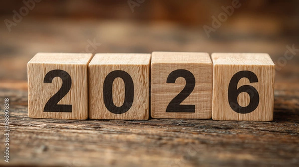 Fototapeta Wooden blocks displaying the year 2026 on a rustic wooden surface, symbolizing future planning, new beginnings, and the passage of time in a creative and artistic manner