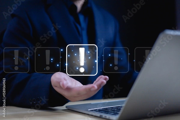 Fototapeta Businessman showing exclamation mark on hand in front of laptop. business development, warning notification, personal data protection, notification, error warning, maintenance