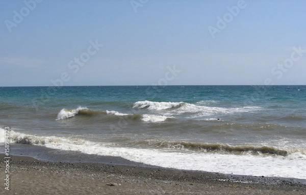 Fototapeta Storm on the sea, the white crests of the waves move to the shore
