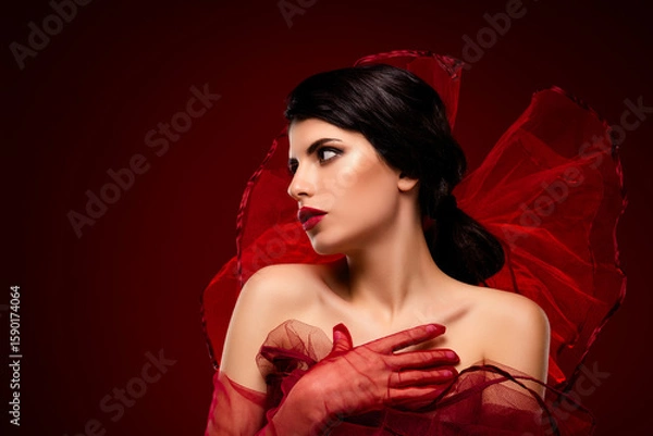 Obraz Elegant young woman in red tulle with a deep crimson background, exuding artistic sensuality and enchanting beauty