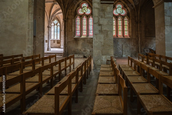 Obraz A quiet, historic church with wooden pews and colorful stained glass windows. Gothic architecture and the play of light create a venerable, tranquil atmosphere