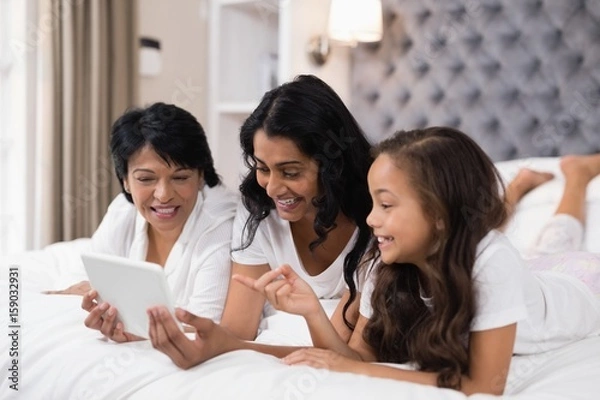 Fototapeta Happy multi-generation family using digital tablet 