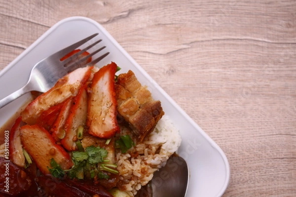 Fototapeta A vibrant plate of rice with Chinese sausage, boiled egg, roasted pork, cucumber slices, and rich savory sauce—bursting with color, texture, and classic Thai-Chinese flavor.