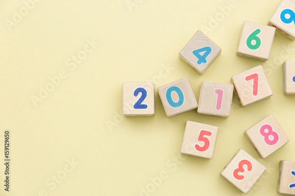 Fototapeta Wooden cubes with numbers on light green background