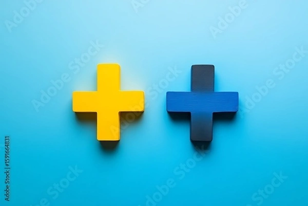 Fototapeta Two Colorful Plus Signs A Yellow Plus and a Blue/Black Plus on Blue
