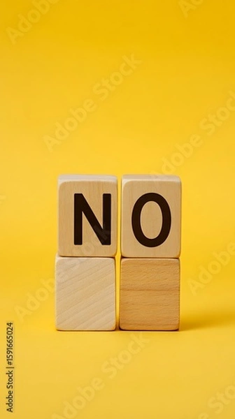 Fototapeta Wooden Blocks Spelling 'NO' on Yellow Backdrop Negative Response, Decline, Refusal