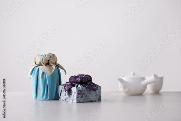 Obraz Elegant Korean table setting with traditional Korean bojagi gift wrapping for Chuseok, ceramic vase and fabric, tree branches.