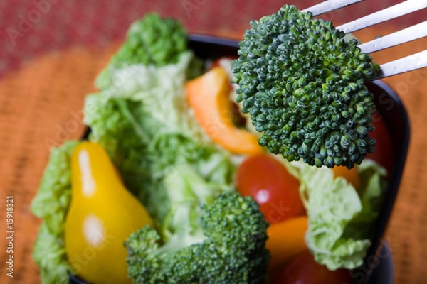 Fototapeta Broccoli on Fork above Salad