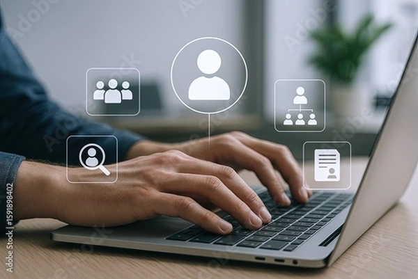 Obraz Person Using Laptop Keyboard with Digital Interface Icons in a Modern Office Setting.