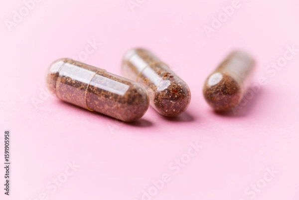 Fototapeta Siberian ginseng (Eleutherococcus senticosus) capsules on bright background. Soft focus. Close up. Copy space	