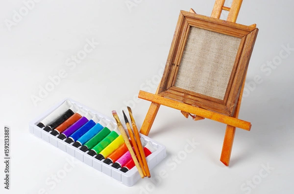 Fototapeta Canvas on a stretcher, art paints and brushes.