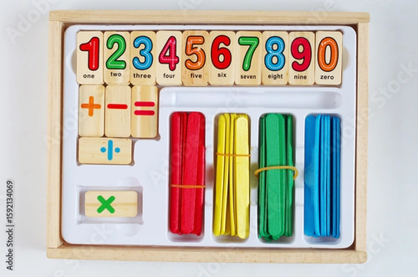 Fototapeta Children's set of numbers and symbols for counting in a wooden box.