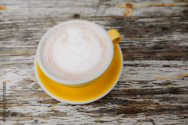 Fototapeta Top view of latte on a yellow tray on a classic wooden table.