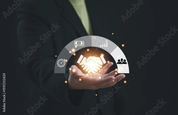 Fototapeta Businessman presenting glowing handshake icon surrounded by business, finance, and collaboration symbols, representing successful partnership, strategic cooperation, and trust in modern alliances.