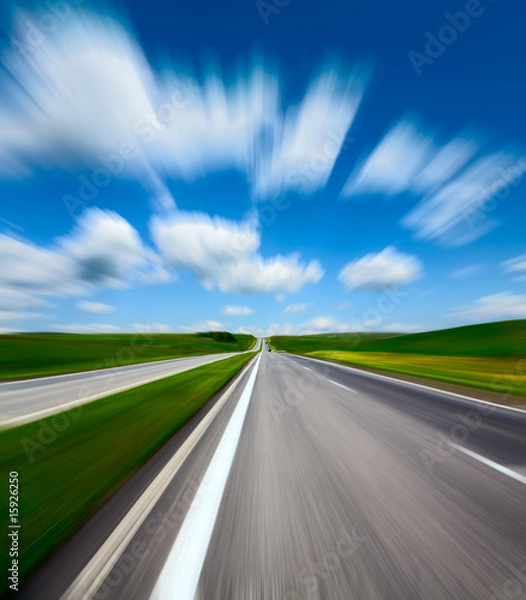 Obraz motion blurred road and cloudy blue sky
