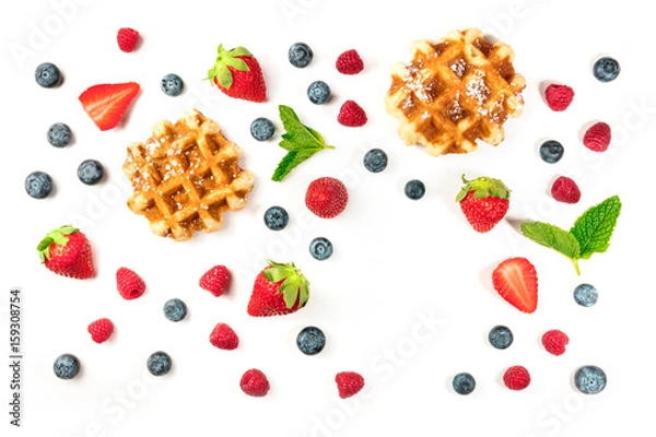 Fototapeta Belgian waffles with fresh fruit, mint leaves, and copyspace