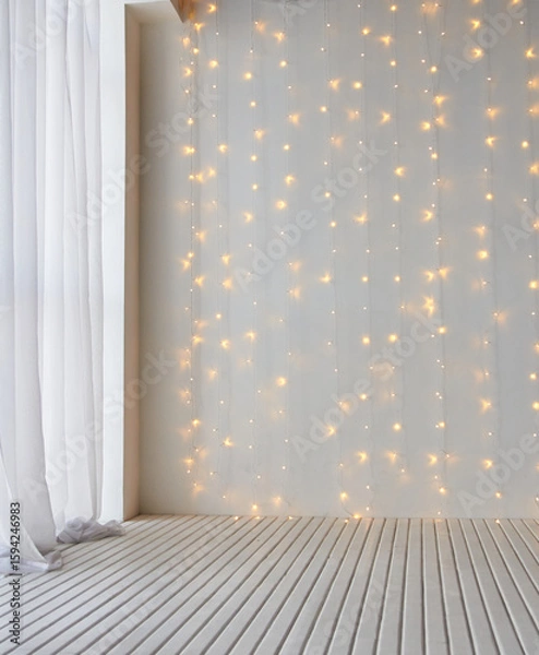 Fototapeta Cozy indoor setting with soft white curtains and warm string lights on white wooden floor.