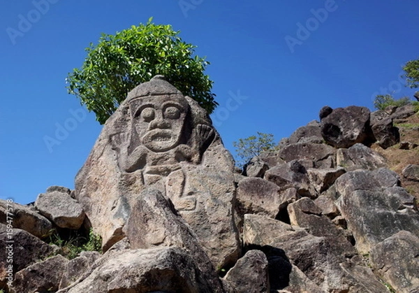 Obraz An ancient rock carving looks out over the valley near San Agustin archaeological park Colombia