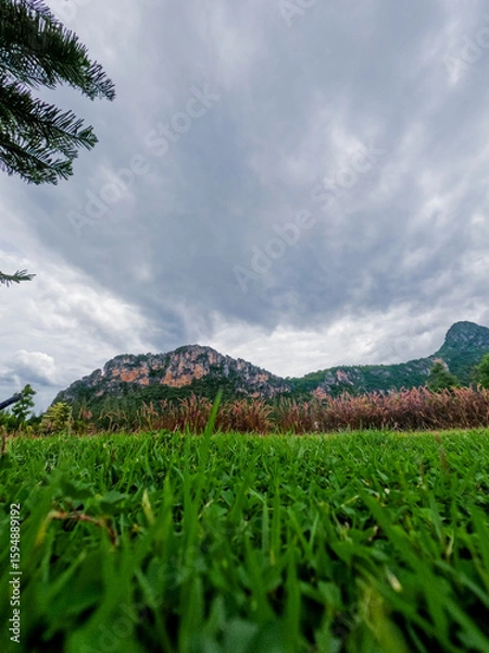 Fototapeta Low-Angle View of Mountain with Green Grass and Overcast Sky