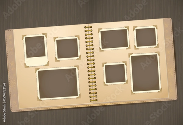 Fototapeta Vintage photo album mockup with empty black photo placeholders on an open spiral-bound scrapbook. The album lies on a wooden surface, showcasing a nostalgic design with beige pages, corner photo mount