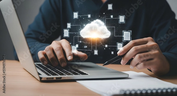 Fototapeta Person working on a laptop with a cloud computing graphic overlay.