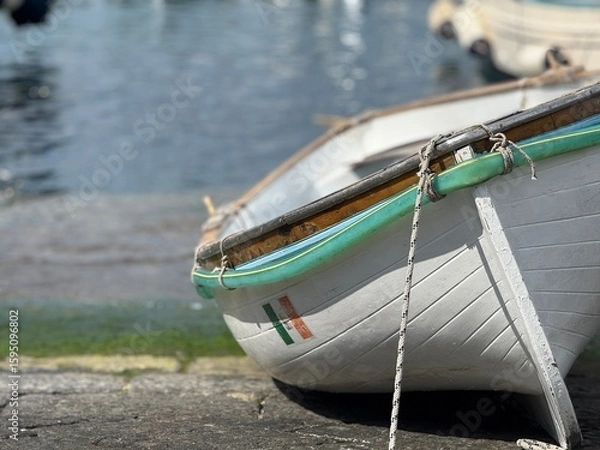 Fototapeta Weathered Boat resting Quietly on the shore