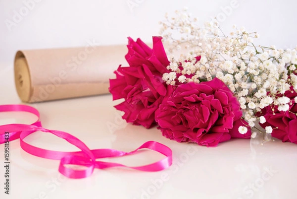 Obraz bouquet of roses is being collected on table in flower shop. Valentine's Day. An atmosphere of creativity and inspiration.