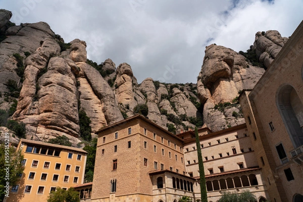 Fototapeta View to the Montserrat monastery or abbey facade in the mountains. Quick cultural landmark near Barcelona for one day escape at any season. 