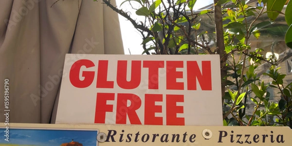 Fototapeta Gluten-free sign displayed outside a restaurant, indicating dietary options for customers in a vibrant setting