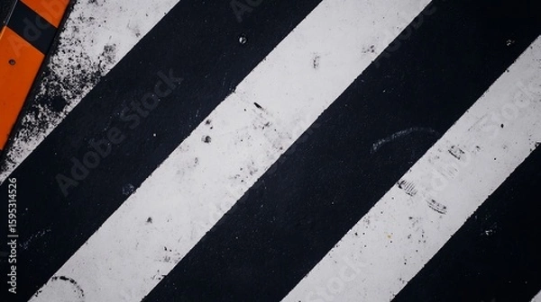 Fototapeta Black and white diagonal stripes creating a dynamic abstract composition, with orange accent