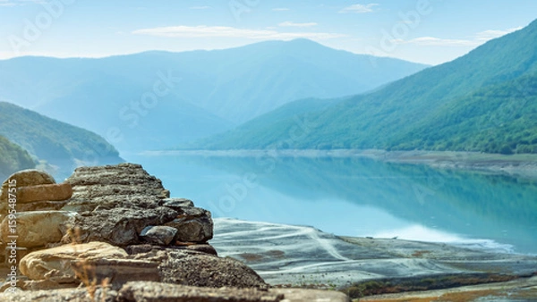 Fototapeta Foreground Focus. Scenic panoramic view from the medieval Ananuri fortress of the Zhinvali Water Reservoir and Caucasus mountains in Georgia, a popular travel destination on the Aragvi River
