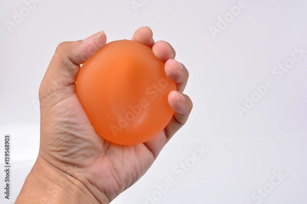 Obraz Hands of a man squeezing a stress ball, Hand Strength Therapy Squeeze Grip Ball